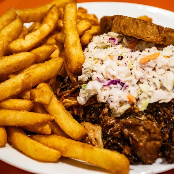 JD's Cafe's southern pulled pork sandwich with coleslaw and a side of golden french fries.
